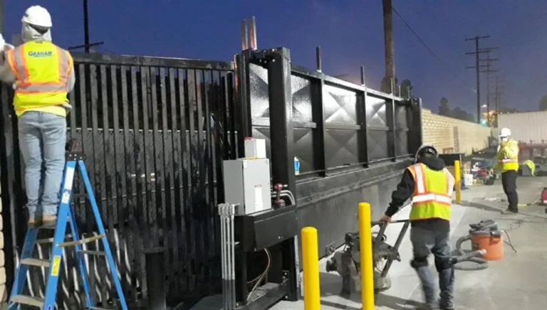 Crew installing a crash-rated sliding gate