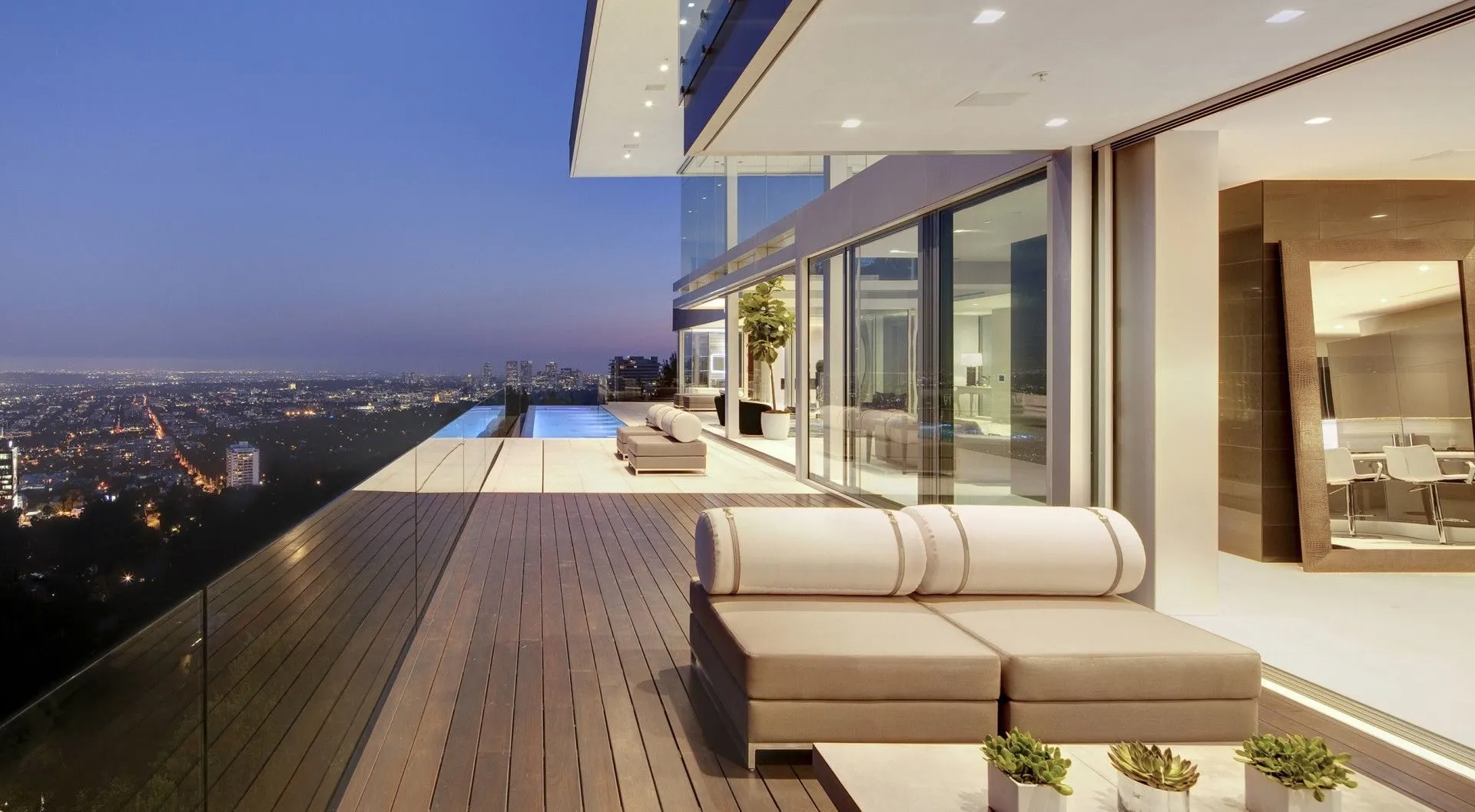 Oriole Way terrace, infinity pool, and city lights at dusk