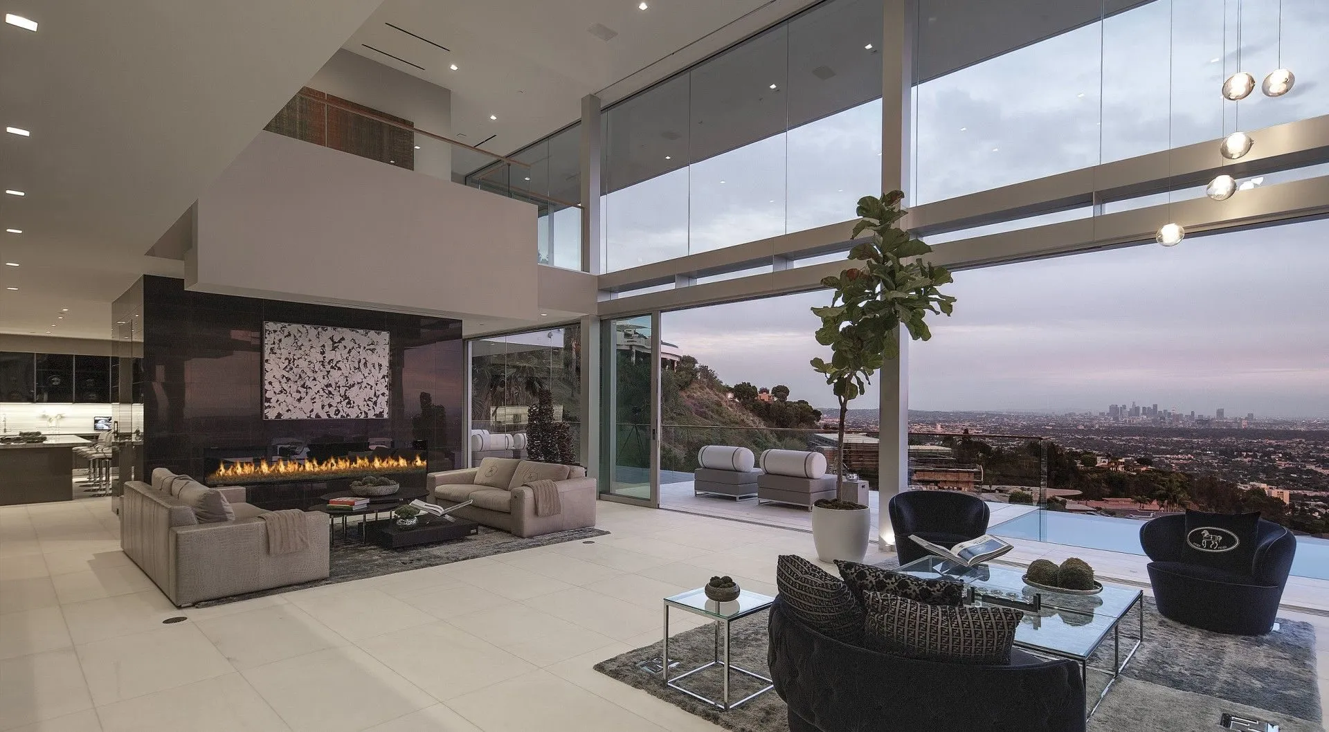 Double-height living room with fireplace and city view
