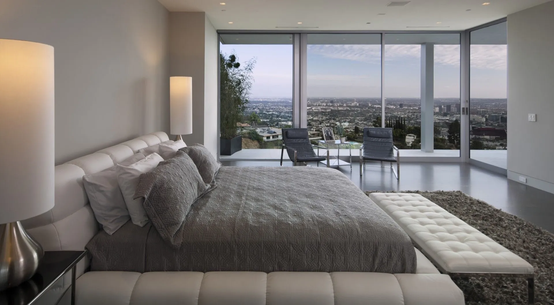 Bedroom with balcony and floor-to-ceiling city views