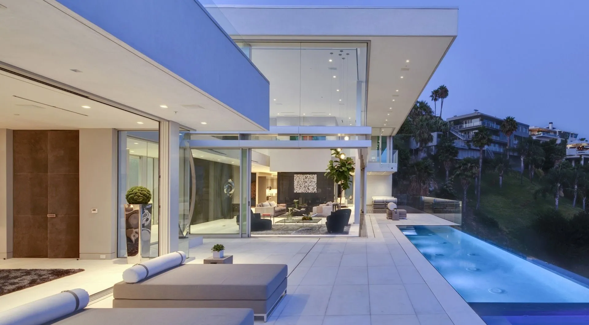 Dusk terrace with infinity pool and outdoor seating