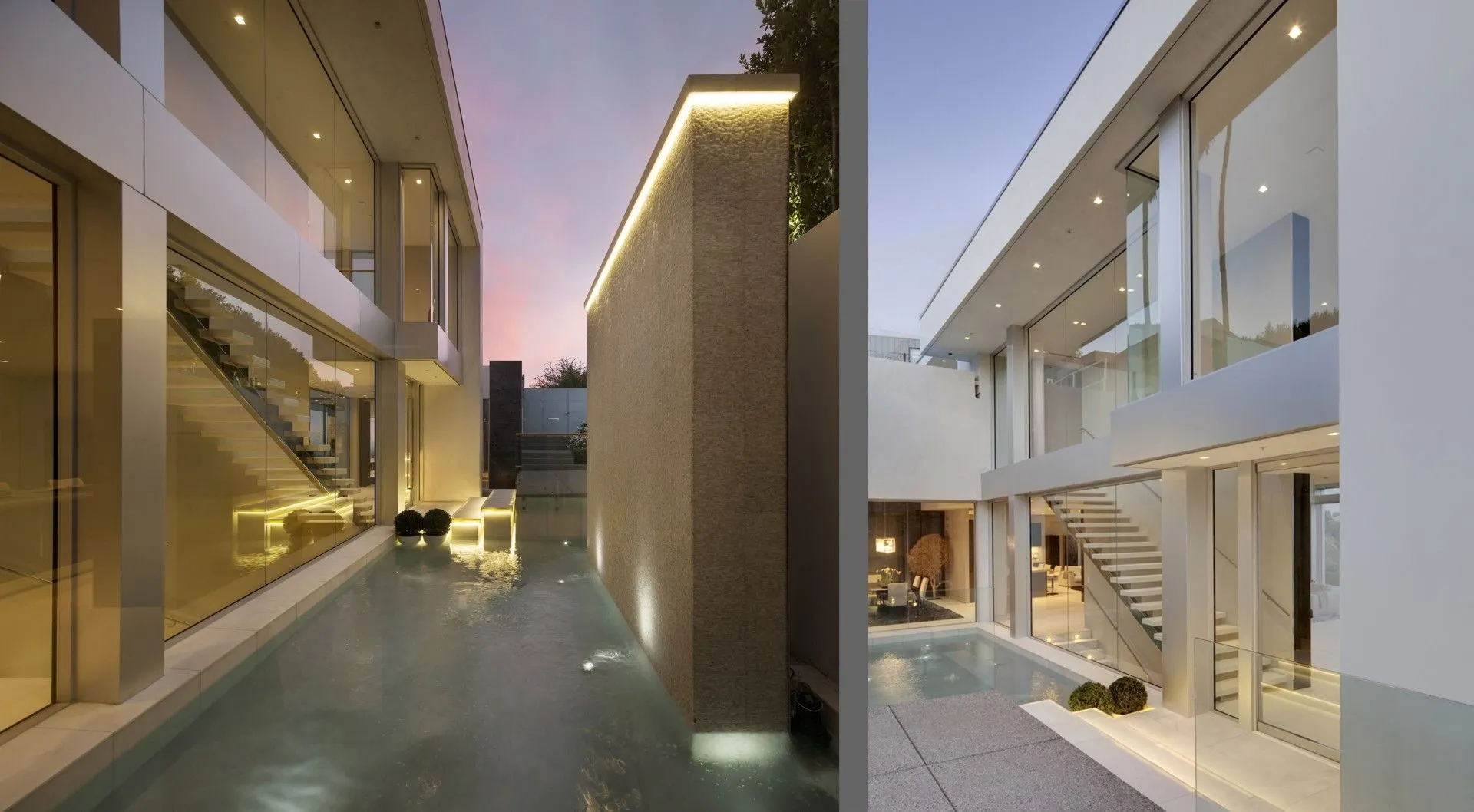 Illuminated entry courtyard with water feature and exterior stair