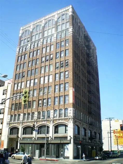 Twelve-story 1912 brick loft building at Santee Court with arched upper-floor windows, Downtown LA Fashion District