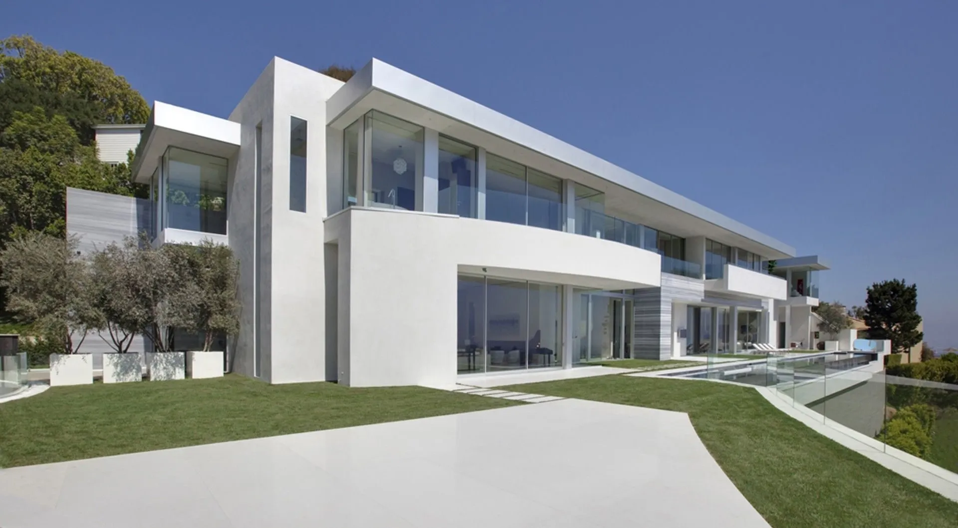 White exterior with lawn and lap pool terrace