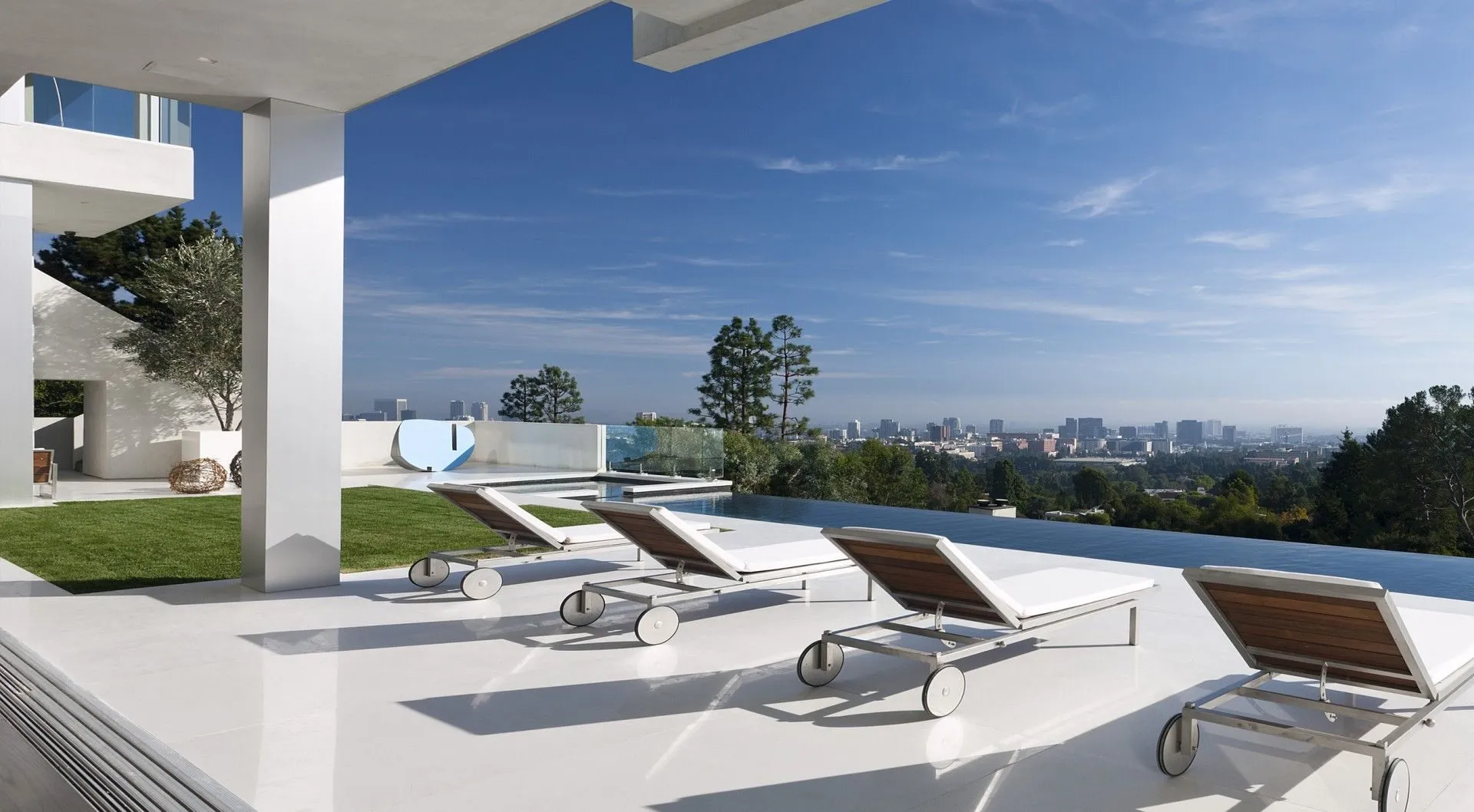 Pool deck with loungers and city view