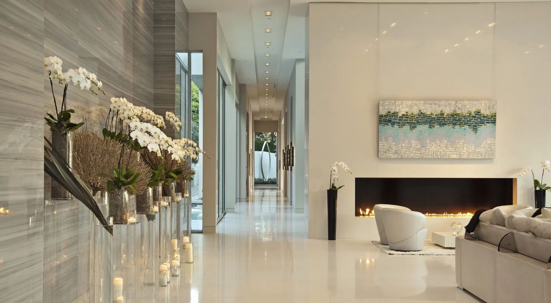 Living area with fireplace and orchid-lined corridor