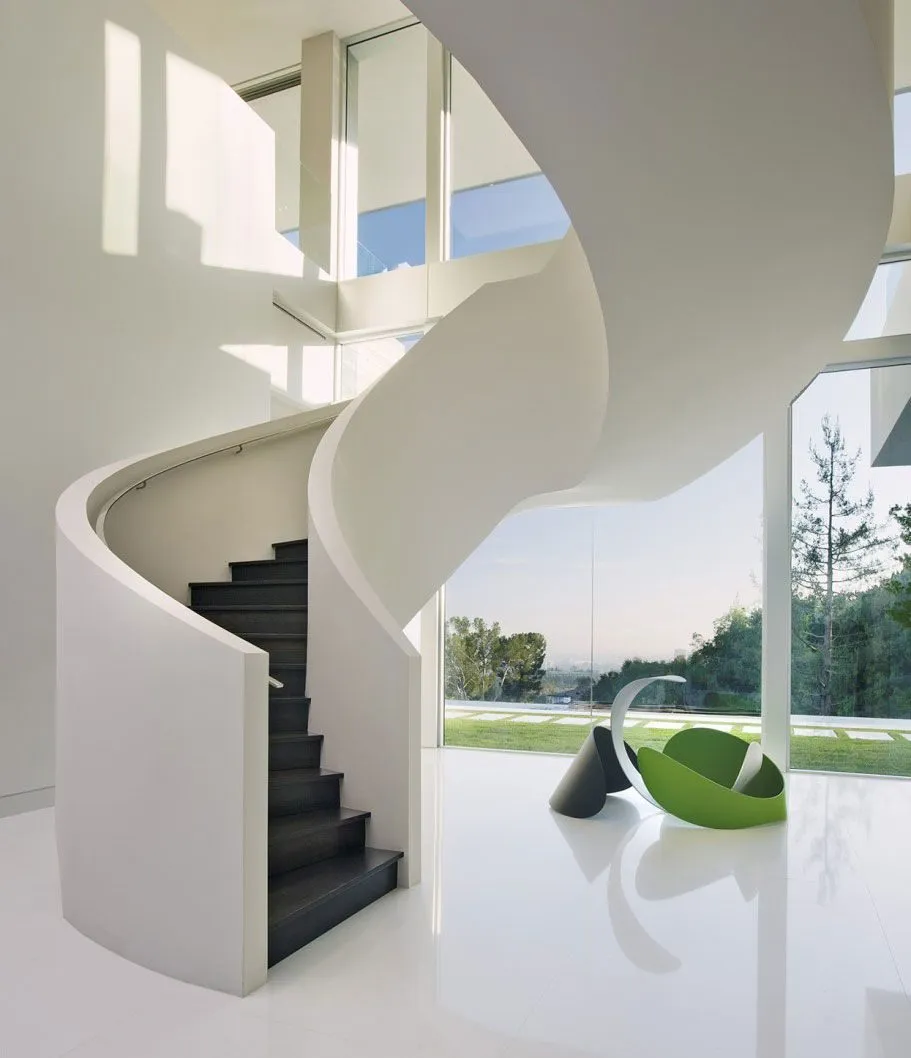 White spiral staircase in a double-height hall