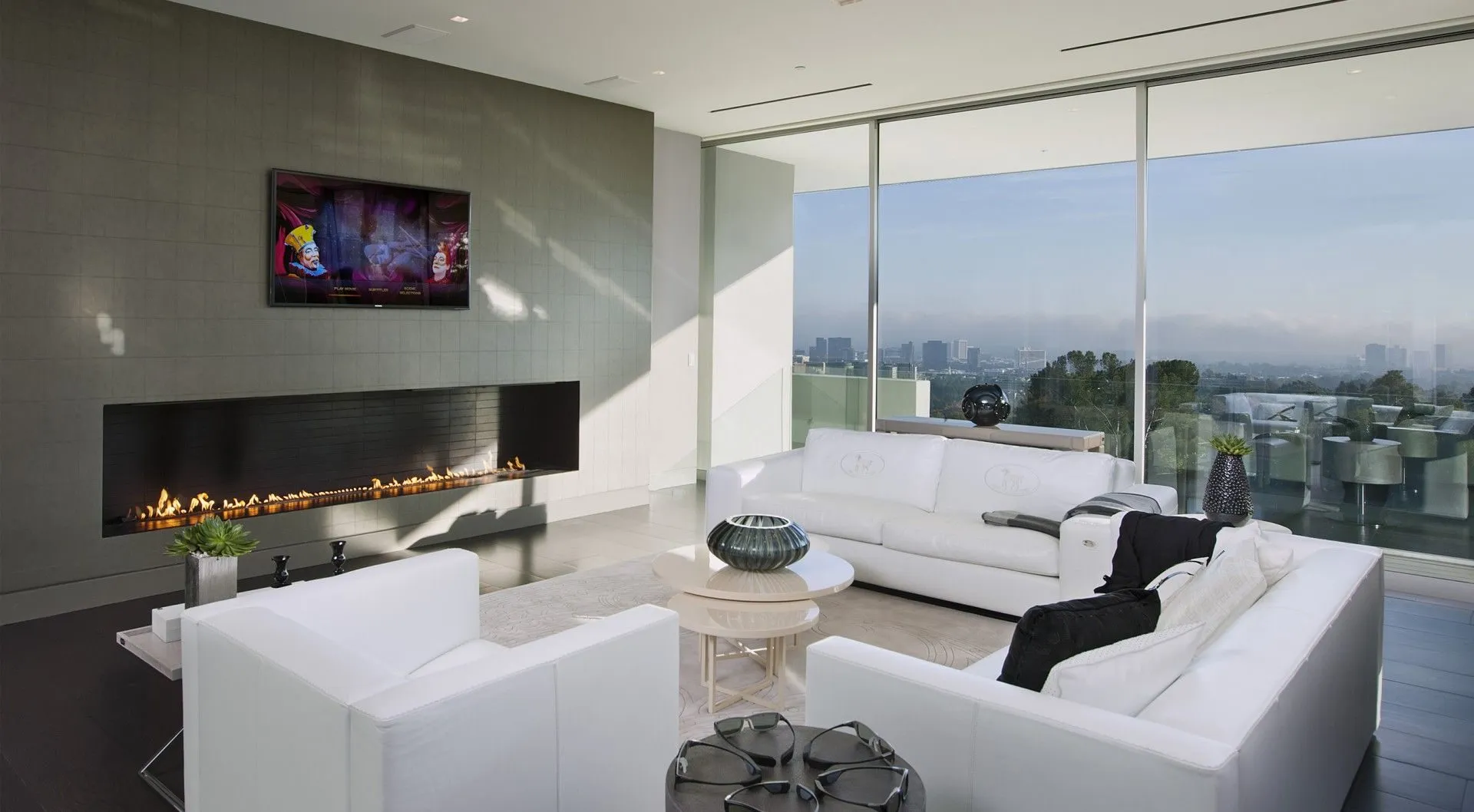 Media lounge with fireplace and city views