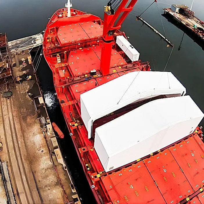Two tension-fabric warehouse modules secured on a cargo ship during open-water transport