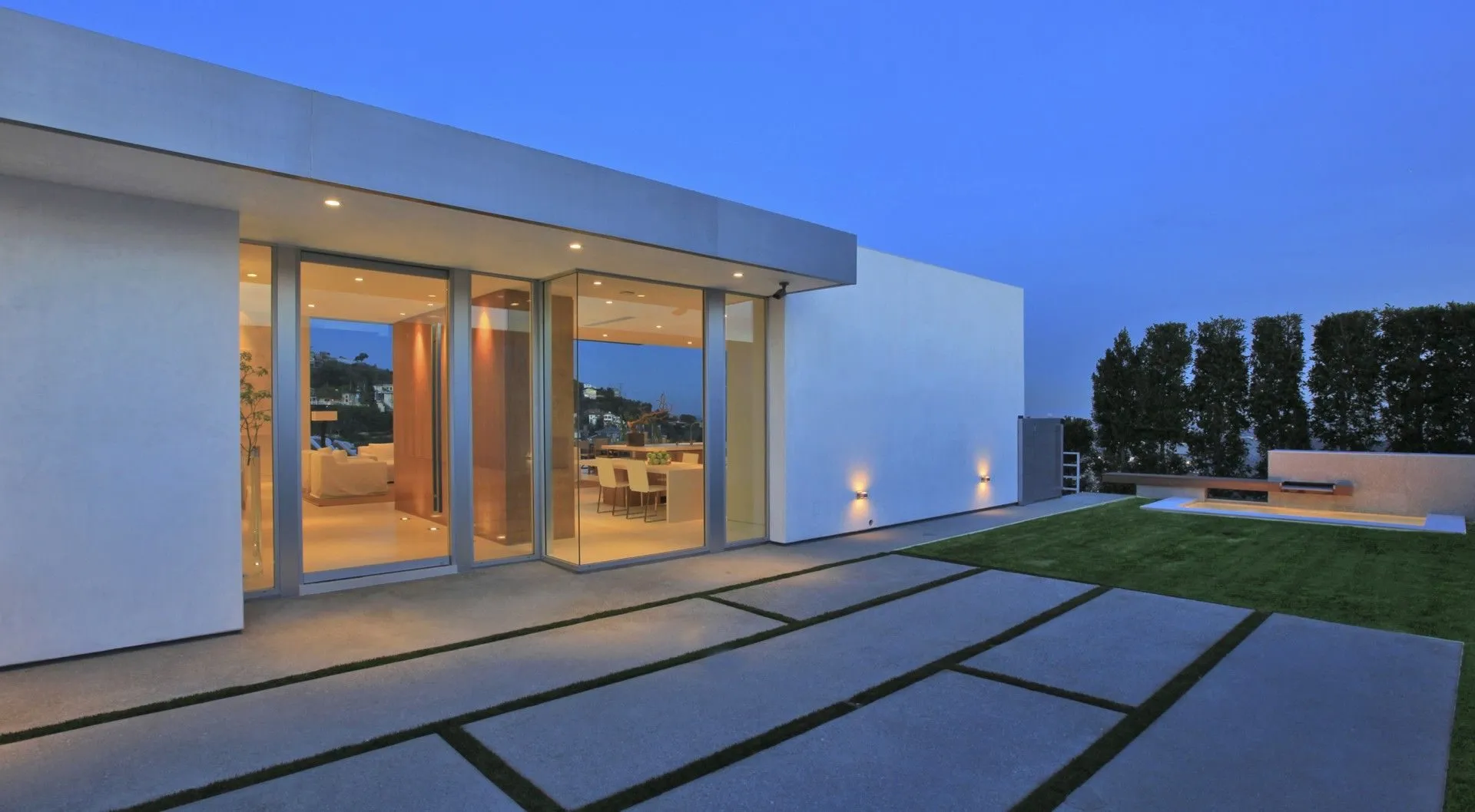 Lawn terrace and contemporary exterior at twilight