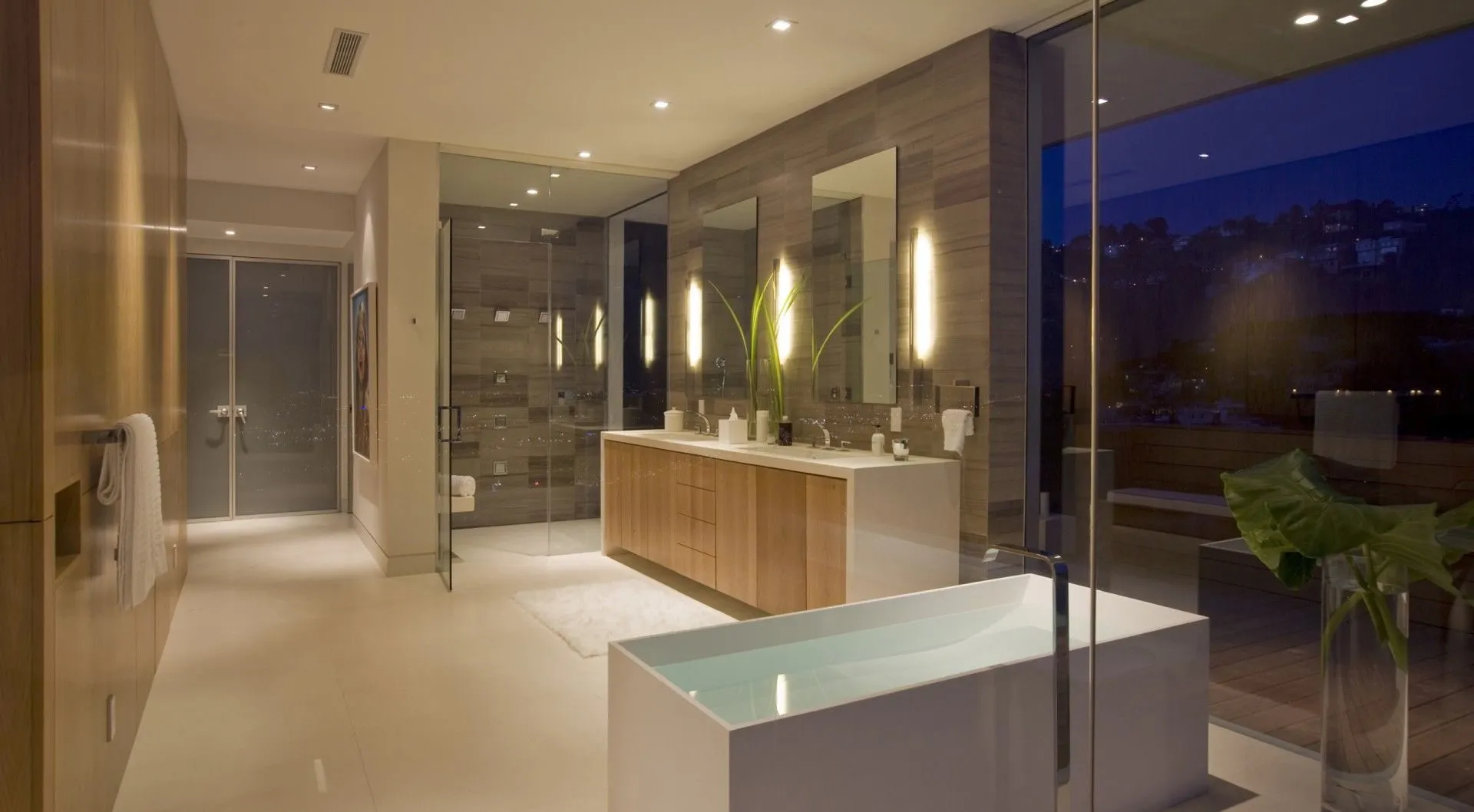 Bathroom with glass-walled tub and long vanity
