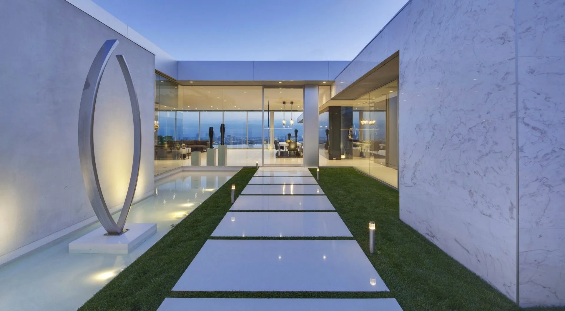 Entry courtyard with reflecting water and circular sculpture