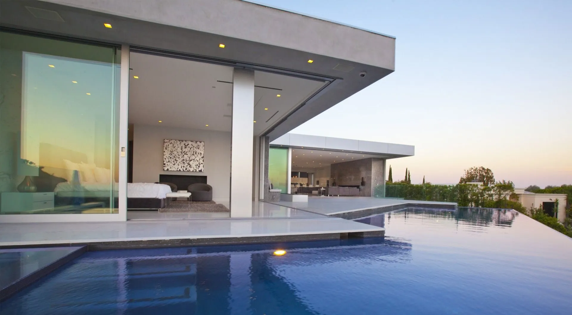 Tanager II cantilevered residence over an infinity pool at sunset