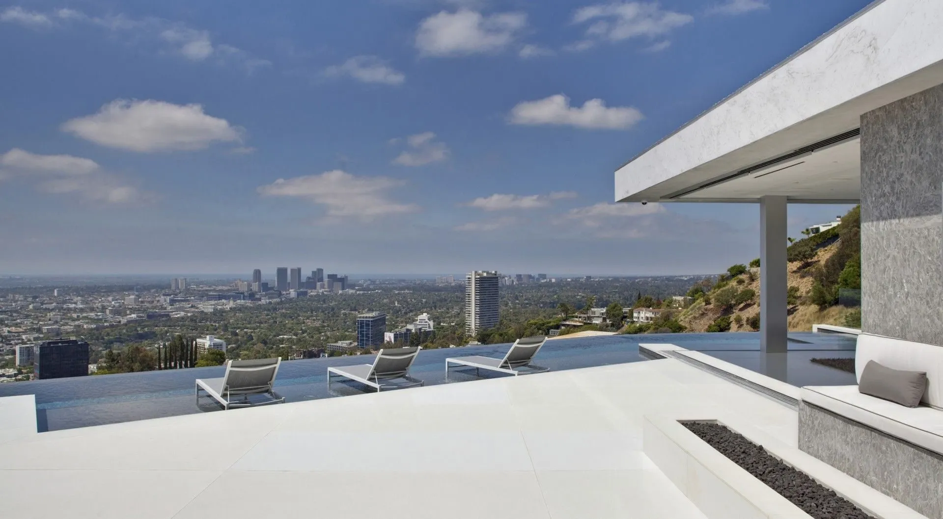 White hillside terrace with city views