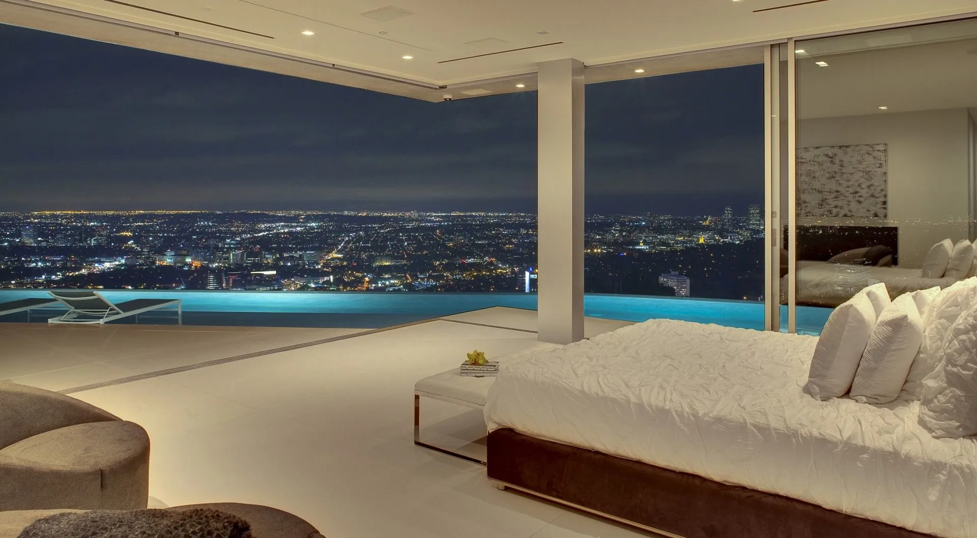 Bedroom with pool edge and city lights view
