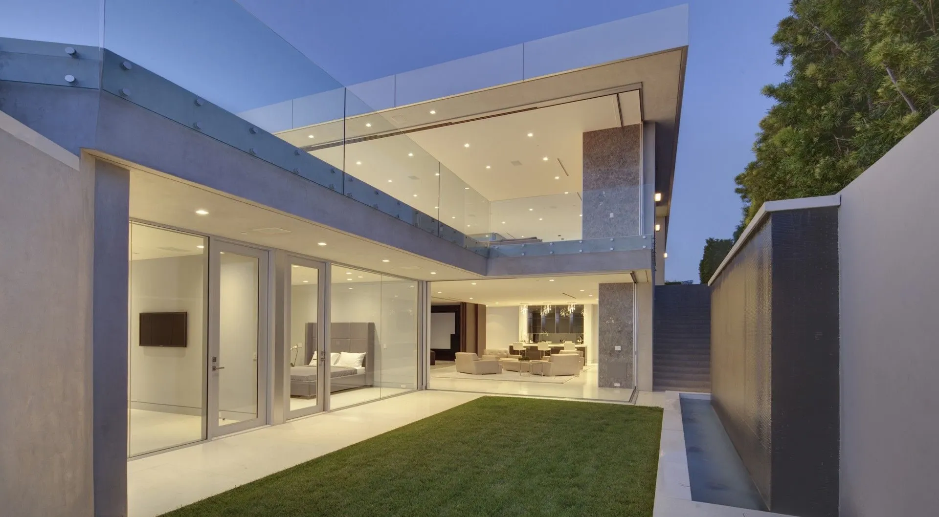Private lawn courtyard beside a white exterior