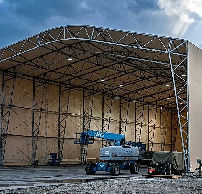 Open tension-fabric aircraft hangar with steel trusses and lift equipment at Tyndall Air Force Base